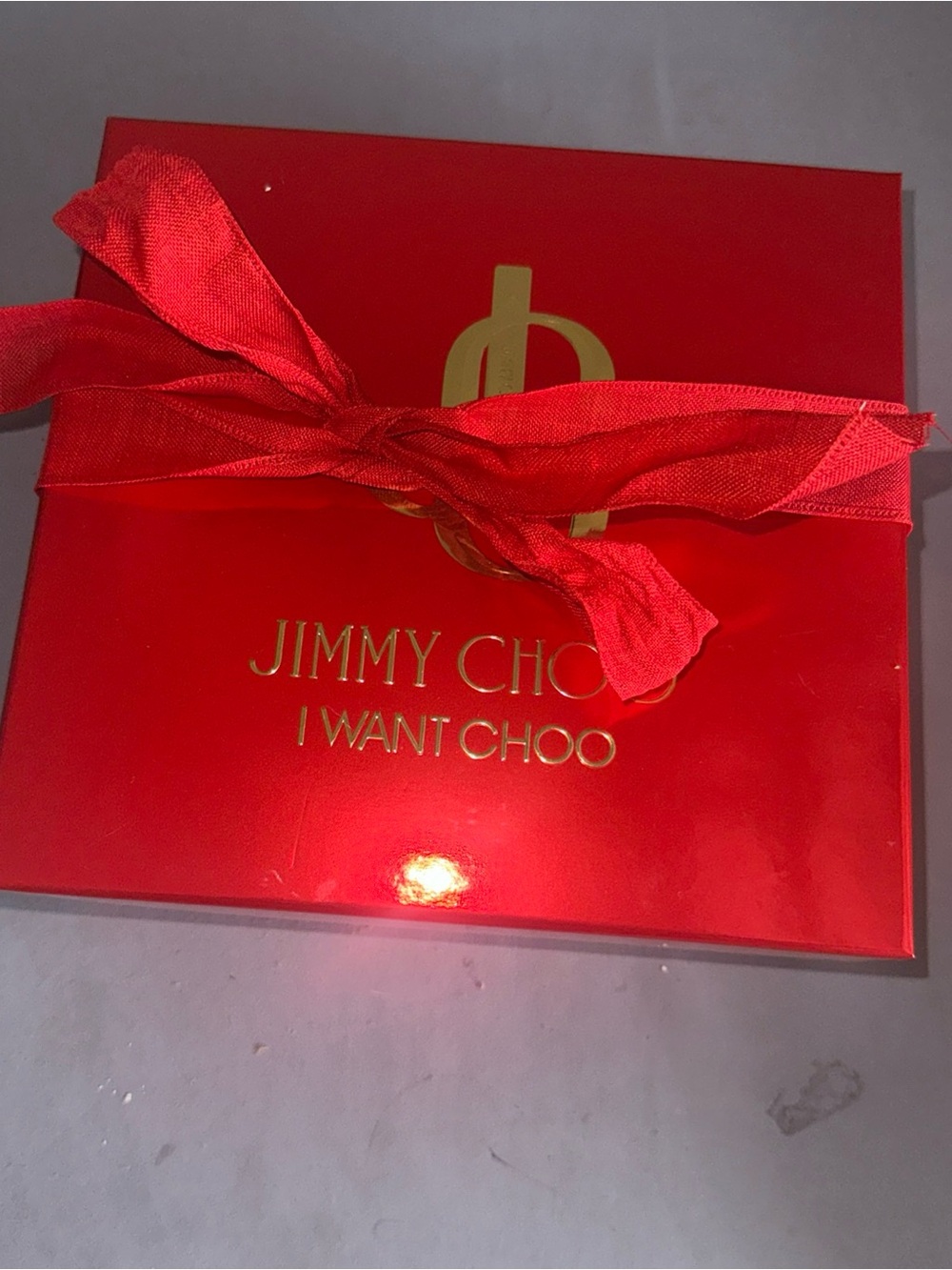 Jimmy Choo red gift box with gold logo and bow
